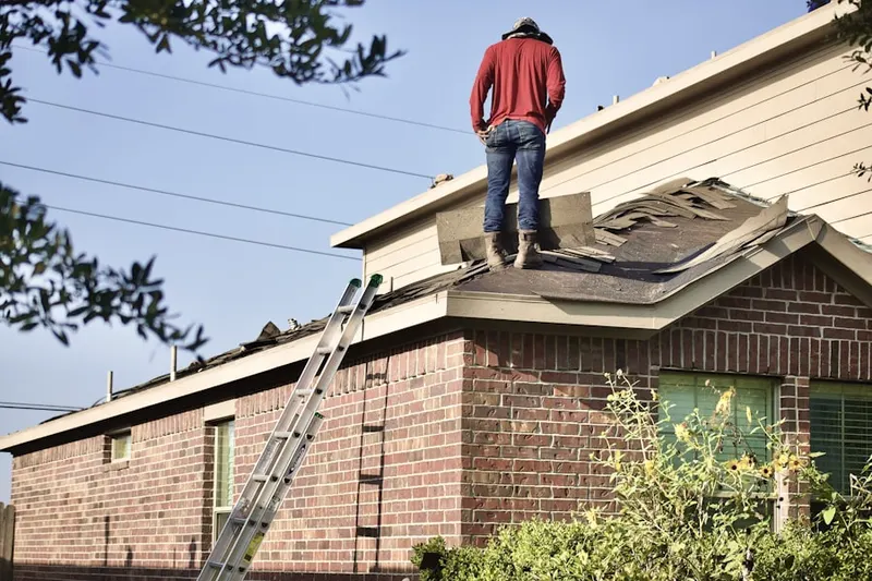 Professional roofer working on a residential roof in East Sharon